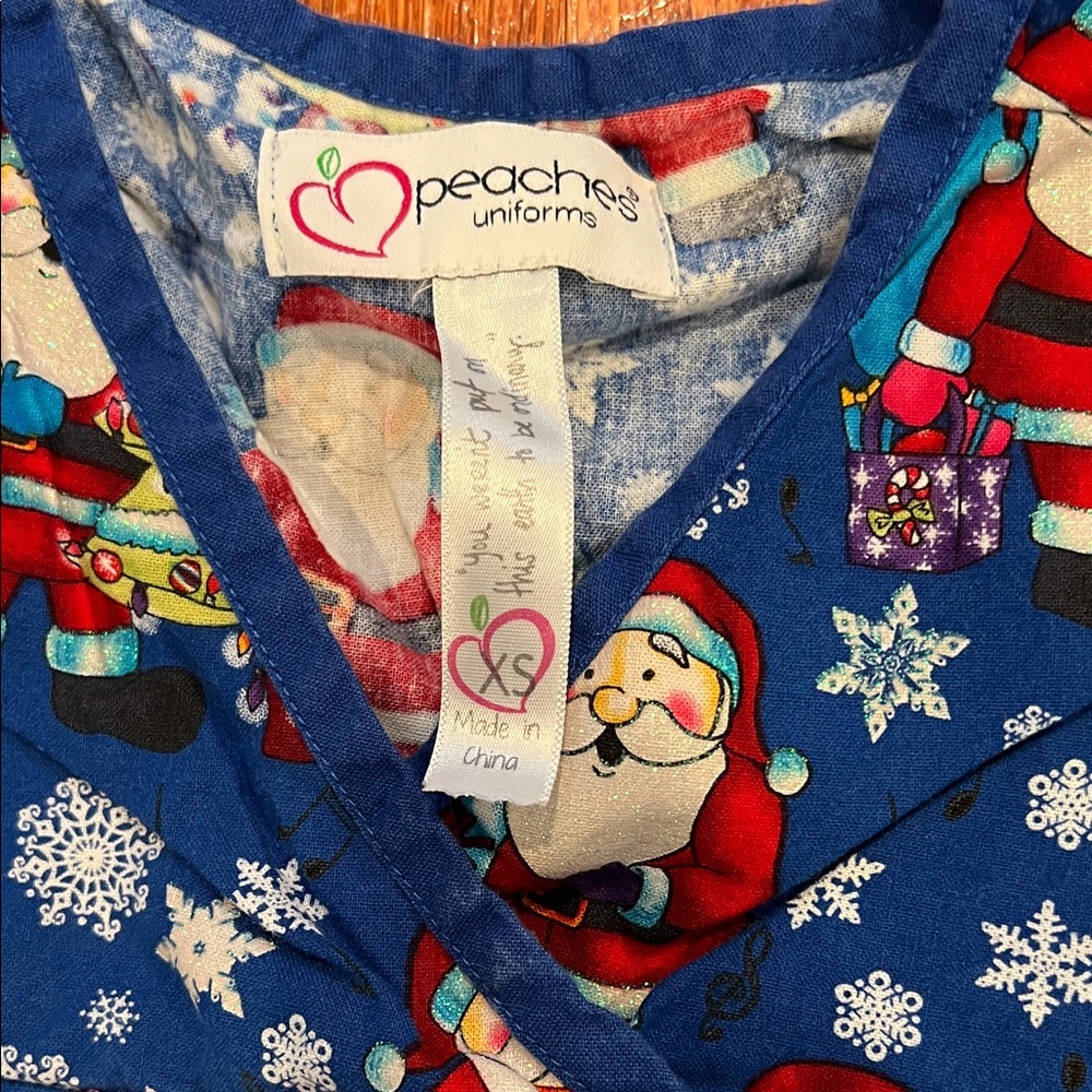 Peaches Uniforms Christmas Scrub Top - Festive Blue Santa Print